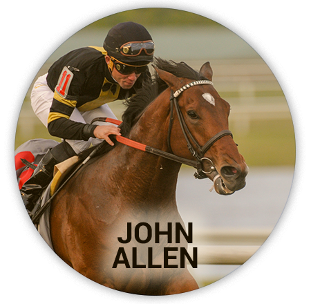 jockey in black jacket and white pants, brown horse