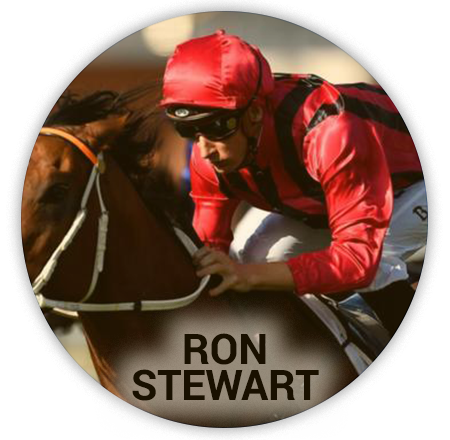 jockey in a red suit and helmet rides a horse